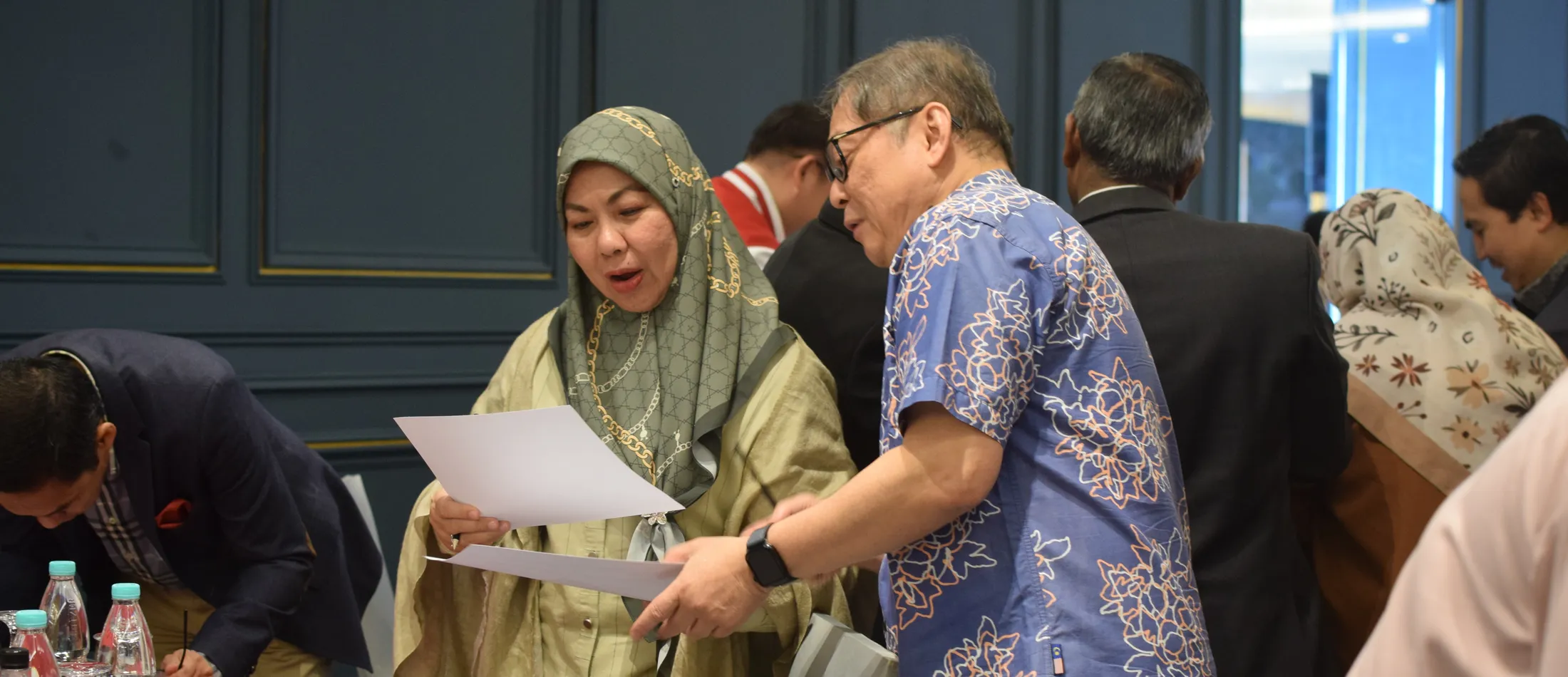 Two participants reviewing programme documents together during a culture transformation engagement