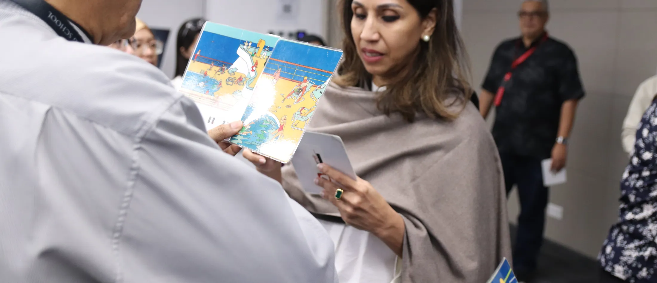 A leadership coaching moment with a trainer reviewing material one-on-one with a participant